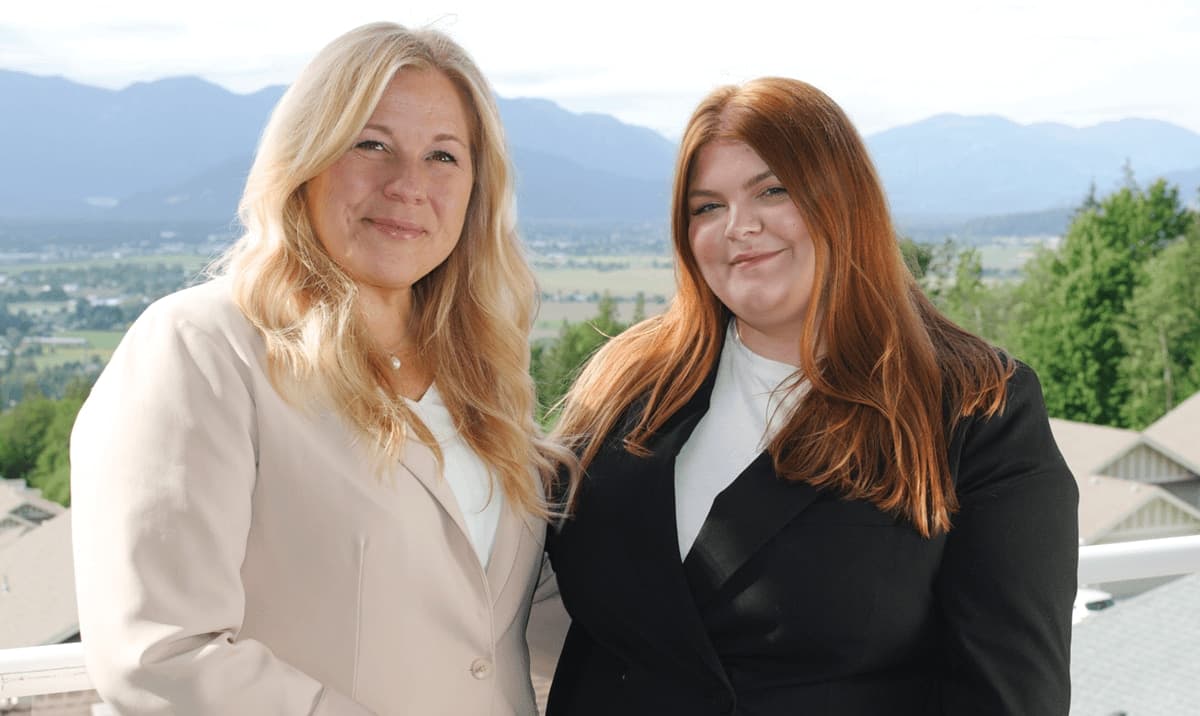 A picture of Alayne and Lauren standing on a patio overlooking Chilliwack